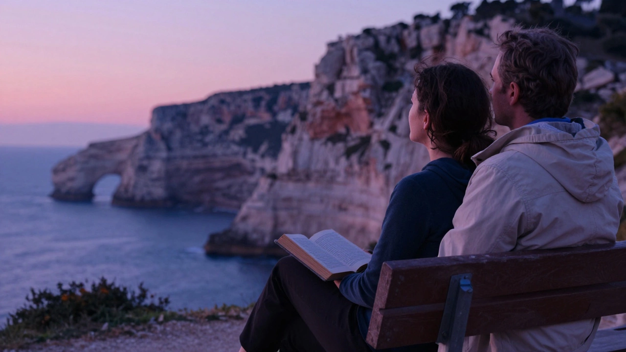 A companion and client sit in silent contemplation on a bench overlooking the Calanques at dusk, the ocean stretching below.